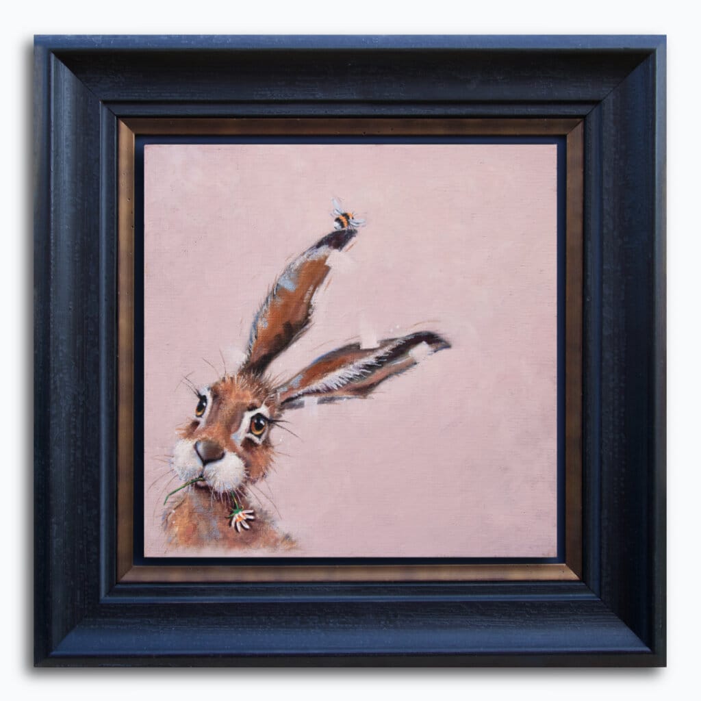 "Bee Hare Now..." painted by renowned UK wildlife artist Ann Richmond, is a charming, whimsical portrait featuring a Bumble Bee that's tickling a Hare's ear... The piece comes alive with vibrant brush strokes over a richly textured canvas, capturing the delicate interplay of nature in a moment of quiet wonder. Each piece in The Wylde Ones is rendered in Richmond’s fresh, energetic, and gestural new style—a deliberate departure from her works in The Otherwurlde Collection. The backgrounds are carefully matched to hues from a heritage palette we affectionately call “Barrow & Fall”; complementing these striking and distinctive portrayals of British wildlife. Discover the original works and fine-art prints at Otherwurlde.com.