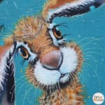 'Bad Hare Day…' is a whimsical study of a young hare sheltering beneath a leaf in a rainstorm — blissfully unaware that it’s dripping more water than it’s stopping. Raindrops splash and scatter across his fur in a scene full of humour, charm, and countryside mischief. A scene full of mischief, warmth, and woodland charm Painted by renowned UK wildlife artist Ann Richmond, the artwork comes alive with vibrant brush strokes over a richly textured canvas, capturing the delicate interplay of nature in a moment of quiet wonder. Each piece in The Wylde Ones is rendered in Richmond’s fresh, energetic, and gestural new style—a deliberate departure from her works in The Otherwurlde Collection. The backgrounds are carefully matched to hues from a heritage palette we affectionately call “Barrow & Fall”; complementing these striking and distinctive portrayals of British wildlife. Discover the original works and fine-art prints at Otherwurlde.com.