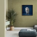 Barn Owlet, created by innovative UK digital artist Gary Hyland, captures the stunning innocence of a baby Barn Owl, delicately placed against a smoothly graduated rich sapphire-blue background. This enchanting piece from the Fauna Collection celebrates the purity and charm of nature through a minimalist yet captivating composition, where the subtle accents in the Owl's feathers resonate with the backdrop. An impossibly cute and gentle vision, Barn Owlet transports us to a timeless, unspoiled realm of natural beauty, blended with a subtle twist of colour. Discover original artworks and fine-art prints from this endearing series at Otherwurlde.com.