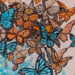 Ascension, the final painting in Ann Richmond's From Whispers to Wings triptych, captures the transformative moment of full acceptance as the young woman’s blue butterfly transforms into ethereal wings. Surrounded by a vibrant assembly of monarchs, she emerges with a sense of clarity, embodying her chosen path within Otherwurlde’s mythical setting. Part of the Otherwurlde Collection, this fantasy art limited edition piece—conceived by renowned UK fantasy artist Ann Richmond and writer Gary Hyland—transports viewers into a magical realm where armoured animals and evocative narratives come to life. Offered as affordable art with story, collectors can choose between the original artwork and an exclusive range of fine-art prints. Discover the enchantment at Otherwurlde.com.