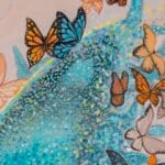 Ascension, the final painting in Ann Richmond's From Whispers to Wings triptych, captures the transformative moment of full acceptance as the young woman’s blue butterfly transforms into ethereal wings. Surrounded by a vibrant assembly of monarchs, she emerges with a sense of clarity, embodying her chosen path within Otherwurlde’s mythical setting. Part of the Otherwurlde Collection, this fantasy art limited edition piece—conceived by renowned UK fantasy artist Ann Richmond and writer Gary Hyland—transports viewers into a magical realm where armoured animals and evocative narratives come to life. Offered as affordable art with story, collectors can choose between the original artwork and an exclusive range of fine-art prints. Discover the enchantment at Otherwurlde.com.