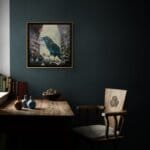 Ravensong… painted by UK fantasy artist Ann Richmond, presents a striking raven at rest within the scribing hall of the Otherwurlde. Usually intent on engraving guidance upon the legendary Pearls of Wisdom, here it pauses—head cocked, beak poised—as though weighing what the next rune should reveal. A golden shaft of light illuminates the shelves and urns around it, symbols of the knowledge entrusted to this enigmatic guardian. The painting reflects an old truth: a bird does not sing because it has an answer, but because it has a song. In this moment of stillness, the raven’s presence suggests that wisdom lies not in final answers, but in the ongoing song itself—the search, the patience, the story unfolding. Part of the Otherwurlde Collection—created in collaboration with writer Gary Hyland—Ravensong invites collectors into a world where armoured animals and hidden narratives converge. Available as the original artwork and in a limited range of fine-art prints. Discover more at Otherwurlde.com.