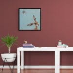 'Harey Landing!', features a little Wren, as it comes in for a landing on what looks to be a suitable perch... We're left wondering at the chaos that will soon ensue! 'Harey Landing!' is the third artwork in this collection by renowned UK wildlife artist Ann Richmond to feature a hare. The piece comes alive with vibrant brush strokes over a richly textured canvas, capturing the delicate interplay of nature in a moment of quiet wonder. Each piece in The Wylde Ones is rendered in Richmond’s fresh, energetic, and gestural new style—a deliberate departure from her works in The Otherwurlde Collection. The backgrounds are carefully matched to hues from a heritage palette we affectionately call “Barrow & Fall”; complementing these striking and distinctive portrayals of British wildlife. Discover the original works and fine-art prints at Otherwurlde.com.