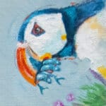 'Catch of the Day...', features a watchful Puffin, whose vigil is rewarded by the return of its partner; its beak overflowing with silvery fish...! Painted by renowned UK wildlife artist Ann Richmond, the artwork comes alive with vibrant brush strokes over a richly textured canvas, capturing the delicate interplay of nature in a moment of quiet wonder. Each piece in The Wylde Ones is rendered in Richmond’s fresh, energetic, and gestural new style—a deliberate departure from her works in The Otherwurlde Collection. The backgrounds are carefully matched to hues from a heritage palette we affectionately call “Barrow & Fall”; complementing these striking and distinctive portrayals of British wildlife. Discover the original works and fine-art prints at Otherwurlde.com.