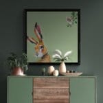 'Harebell...' features a vigilant Hare, who has suddenly heard the 'BUZZ!' of a bumblebee, but can't place the source: all he can see is the distinctive trumpet of a Morning Glory flower... Can YOU spot it? Painted by renowned UK wildlife artist Ann Richmond, the artwork comes alive with vibrant brush strokes over a richly textured canvas, capturing the delicate interplay of nature in a moment of quiet wonder. Each piece in The Wylde Ones is rendered in Richmond’s fresh, energetic, and gestural new style—a deliberate departure from her works in The Otherwurlde Collection. The backgrounds are carefully matched to hues from a heritage palette we affectionately call “Barrow & Fall”; complementing these striking and distinctive portrayals of British wildlife. Discover the original works and fine-art prints at Otherwurlde.com.