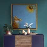 'Sunny Side Up!' This beautiful painting celebrates the noble fox at his best, as he stares awestruck at a glowing sunflower in all its glory. While it's true that you should 'never stare at the sun', we'd make an exception for this one! Painted by renowned UK wildlife artist Ann Richmond, the artwork comes alive with vibrant brush strokes over a richly textured canvas, capturing the delicate interplay of nature in a moment of quiet wonder. Each piece in The Wylde Ones is rendered in Richmond’s fresh, energetic, and gestural new style—a deliberate departure from her works in The Otherwurlde Collection. The backgrounds are carefully matched to hues from a heritage palette we affectionately call “Barrow & Fall”; complementing these striking and distinctive portrayals of British wildlife. Discover the original works and fine-art prints at Otherwurlde.com.