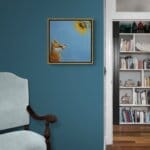 'Sunny Side Up!' This beautiful painting celebrates the noble fox at his best, as he stares awestruck at a glowing sunflower in all its glory. While it's true that you should 'never stare at the sun', we'd make an exception for this one! Painted by renowned UK wildlife artist Ann Richmond, the artwork comes alive with vibrant brush strokes over a richly textured canvas, capturing the delicate interplay of nature in a moment of quiet wonder. Each piece in The Wylde Ones is rendered in Richmond’s fresh, energetic, and gestural new style—a deliberate departure from her works in The Otherwurlde Collection. The backgrounds are carefully matched to hues from a heritage palette we affectionately call “Barrow & Fall”; complementing these striking and distinctive portrayals of British wildlife. Discover the original works and fine-art prints at Otherwurlde.com.