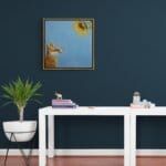 'Sunny Side Up!' This beautiful painting celebrates the noble fox at his best, as he stares awestruck at a glowing sunflower in all its glory. While it's true that you should 'never stare at the sun', we'd make an exception for this one! Painted by renowned UK wildlife artist Ann Richmond, the artwork comes alive with vibrant brush strokes over a richly textured canvas, capturing the delicate interplay of nature in a moment of quiet wonder. Each piece in The Wylde Ones is rendered in Richmond’s fresh, energetic, and gestural new style—a deliberate departure from her works in The Otherwurlde Collection. The backgrounds are carefully matched to hues from a heritage palette we affectionately call “Barrow & Fall”; complementing these striking and distinctive portrayals of British wildlife. Discover the original works and fine-art prints at Otherwurlde.com.