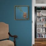 'Love in a Cold Climate...' is a loose sequel to the earlier piece 'Big Drip, Little Owl!'. In this latest painting, the featured character is a beautifully painted Horned Owl that has a little yellow snail sitting at the tip of one of its ears. Look closer: the snail has made contact with another that's balanced on an overhanging leaf! Little wonder that the owl looks so grumpy! Painted by renowned UK wildlife artist Ann Richmond, the artwork comes alive with vibrant brush strokes over a richly textured canvas, capturing the delicate interplay of nature in a moment of quiet wonder. Each piece in The Wylde Ones is rendered in Richmond’s fresh, energetic, and gestural new style—a deliberate departure from her works in The Otherwurlde Collection. The backgrounds are carefully matched to hues from a heritage palette we affectionately call “Barrow & Fall”; complementing these striking and distinctive portrayals of British wildlife. Discover the original works and fine-art prints at Otherwurlde.com.