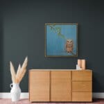 'Love in a Cold Climate...' is a loose sequel to the earlier piece 'Big Drip, Little Owl!'. In this latest painting, the featured character is a beautifully painted Horned Owl that has a little yellow snail sitting at the tip of one of its ears. Look closer: the snail has made contact with another that's balanced on an overhanging leaf! Little wonder that the owl looks so grumpy! Painted by renowned UK wildlife artist Ann Richmond, the artwork comes alive with vibrant brush strokes over a richly textured canvas, capturing the delicate interplay of nature in a moment of quiet wonder. Each piece in The Wylde Ones is rendered in Richmond’s fresh, energetic, and gestural new style—a deliberate departure from her works in The Otherwurlde Collection. The backgrounds are carefully matched to hues from a heritage palette we affectionately call “Barrow & Fall”; complementing these striking and distinctive portrayals of British wildlife. Discover the original works and fine-art prints at Otherwurlde.com.