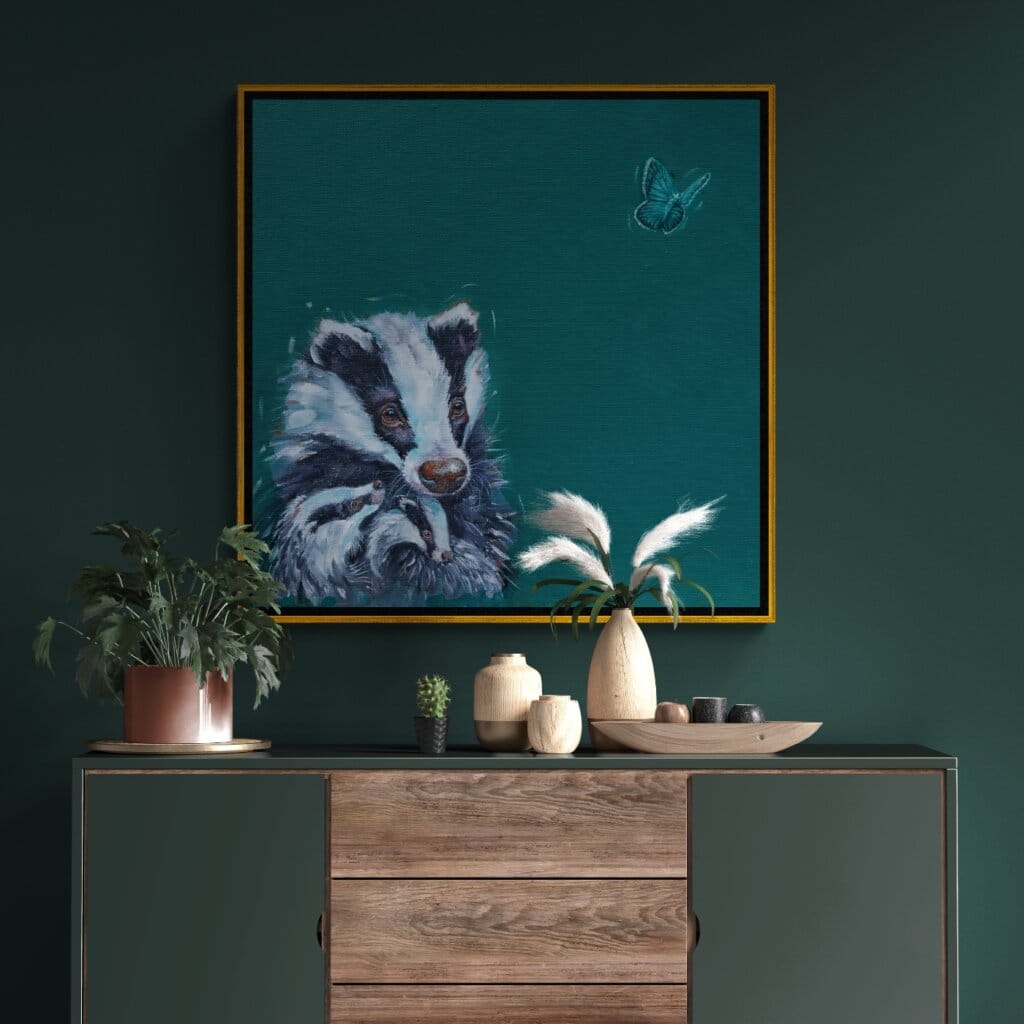 'Flutterby…' captures a tender woodland moment as two young badger cubs nestle into their mother’s warm embrace. Wide-eyed with curiosity, they watch an ethereal Chalk Blue butterfly drift past, while their mother offers the calm assurance that all is well in their little world. A scene full of mischief, warmth, and woodland charm Painted by renowned UK wildlife artist Ann Richmond, the artwork comes alive with vibrant brush strokes over a richly textured canvas, capturing the delicate interplay of nature in a moment of quiet wonder. Each piece in The Wylde Ones is rendered in Richmond’s fresh, energetic, and gestural new style—a deliberate departure from her works in The Otherwurlde Collection. The backgrounds are carefully matched to hues from a heritage palette we affectionately call “Barrow & Fall”; complementing these striking and distinctive portrayals of British wildlife. Discover the original works and fine-art prints at Otherwurlde.com.