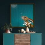 “Moongazing…” captures a quietly evocative moment as a hare stretches its neck, transfixed by the glow of a full moon. A pale moth drifts past its nose, unnoticed, as the hardy creature remains utterly absorbed in the mystery of the night sky. Painted by renowned UK wildlife artist Ann Richmond, the artwork comes alive with vibrant brush strokes over a richly textured canvas, capturing the delicate interplay of nature in a moment of quiet wonder. Each piece in The Wylde Ones is rendered in Richmond’s fresh, energetic, and gestural new style—a deliberate departure from her works in The Otherwurlde Collection. The backgrounds are carefully matched to hues from a heritage palette we affectionately call “Barrow & Fall”; complementing these striking and distinctive portrayals of British wildlife. Discover the original works and fine-art prints at Otherwurlde.com.