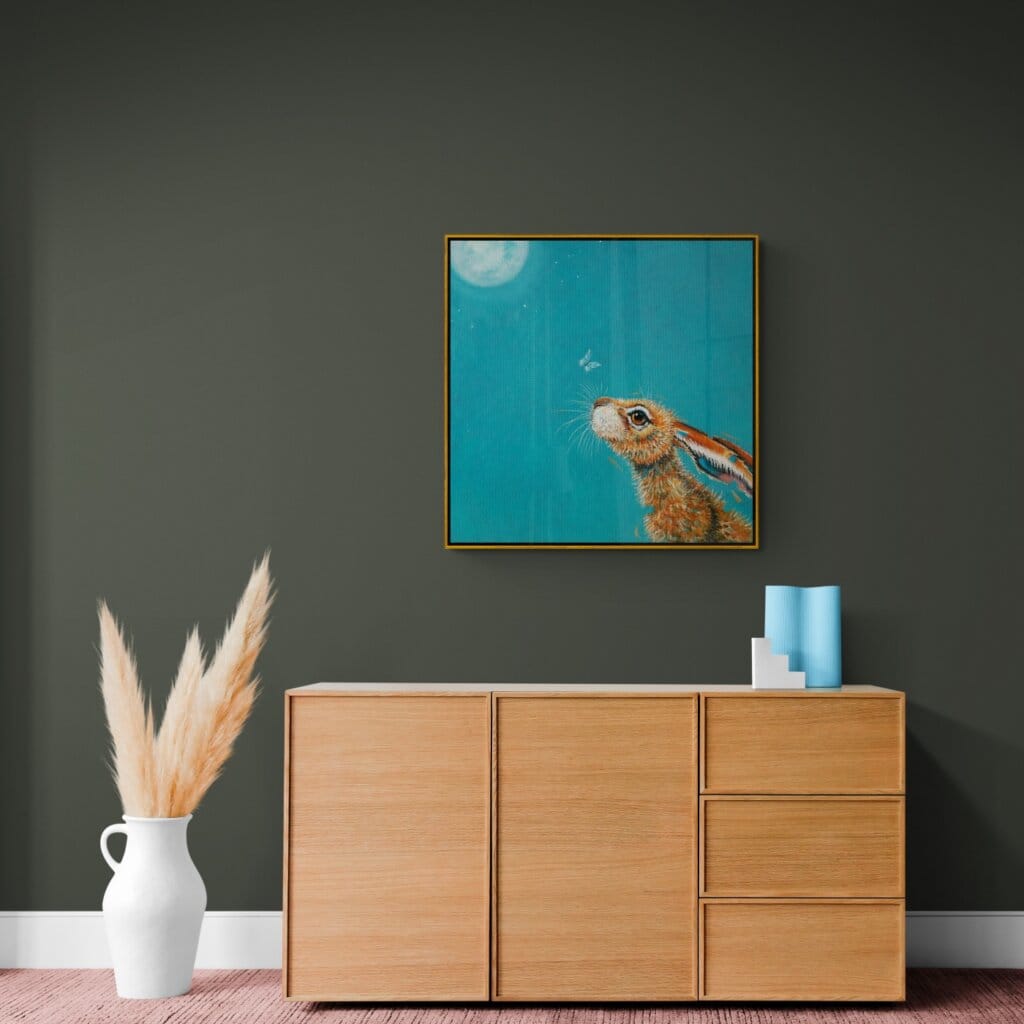 “Moongazing…” captures a quietly evocative moment as a hare stretches its neck, transfixed by the glow of a full moon. A pale moth drifts past its nose, unnoticed, as the hardy creature remains utterly absorbed in the mystery of the night sky. Painted by renowned UK wildlife artist Ann Richmond, the artwork comes alive with vibrant brush strokes over a richly textured canvas, capturing the delicate interplay of nature in a moment of quiet wonder. Each piece in The Wylde Ones is rendered in Richmond’s fresh, energetic, and gestural new style—a deliberate departure from her works in The Otherwurlde Collection. The backgrounds are carefully matched to hues from a heritage palette we affectionately call “Barrow & Fall”; complementing these striking and distinctive portrayals of British wildlife. Discover the original works and fine-art prints at Otherwurlde.com.