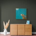 “Moongazing…” captures a quietly evocative moment as a hare stretches its neck, transfixed by the glow of a full moon. A pale moth drifts past its nose, unnoticed, as the hardy creature remains utterly absorbed in the mystery of the night sky. Painted by renowned UK wildlife artist Ann Richmond, the artwork comes alive with vibrant brush strokes over a richly textured canvas, capturing the delicate interplay of nature in a moment of quiet wonder. Each piece in The Wylde Ones is rendered in Richmond’s fresh, energetic, and gestural new style—a deliberate departure from her works in The Otherwurlde Collection. The backgrounds are carefully matched to hues from a heritage palette we affectionately call “Barrow & Fall”; complementing these striking and distinctive portrayals of British wildlife. Discover the original works and fine-art prints at Otherwurlde.com.