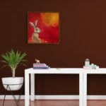 “Hare, Dryer…” presents a serene portrait of a hare at dawn, bathed in the soft warmth of a rising sun. Set against rich tones of red, yellow, and marigold, the hare rests calmly among oversized, abstracted flowers — a quietly radiant scene that speaks of warmth, stillness, and gentle renewal. Painted by renowned UK wildlife artist Ann Richmond, the artwork comes alive with vibrant brush strokes over a richly textured canvas, capturing the delicate interplay of nature in a moment of quiet wonder. Each piece in The Wylde Ones is rendered in Richmond’s fresh, energetic, and gestural new style—a deliberate departure from her works in The Otherwurlde Collection. The backgrounds are carefully matched to hues from a heritage palette we affectionately call “Barrow & Fall”; complementing these striking and distinctive portrayals of British wildlife. Discover the original works and fine-art prints at Otherwurlde.com.